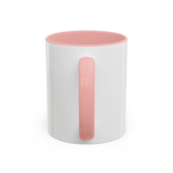 A pink and white coffee mug is sitting on the table.