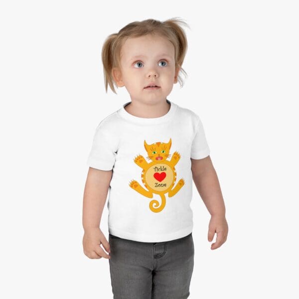 A toddler wearing a t-shirt with an image of a cat.