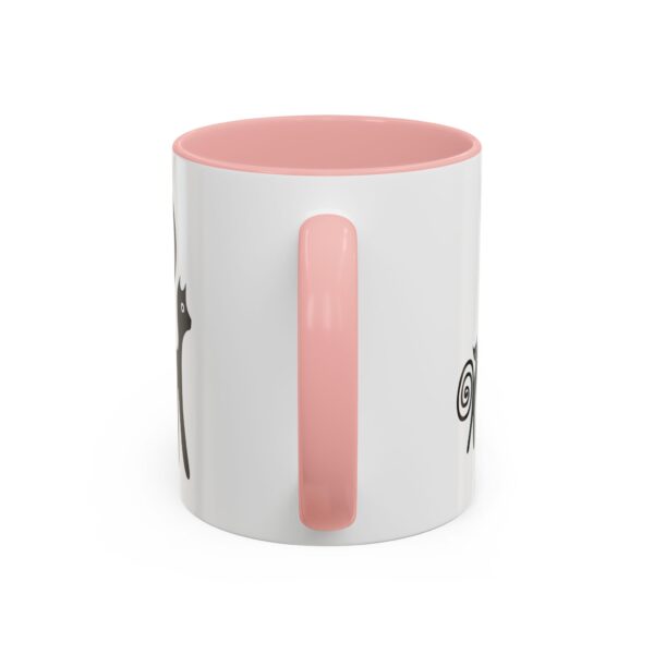 A pink and white mug with a cat on it