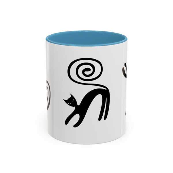 A white and blue mug with black cats on it