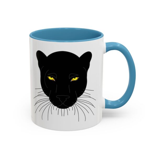 A white and blue mug with a black cat face on it.