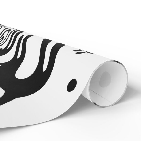 A roll of black and white paper with an abstract design.