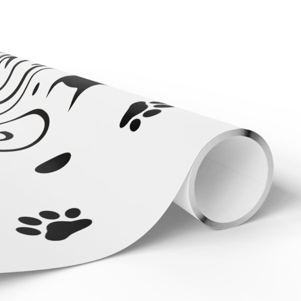 A roll of wrapping paper with a picture of a woman 's face and paw prints.