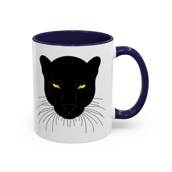 A white and blue mug with a black cat face on it.