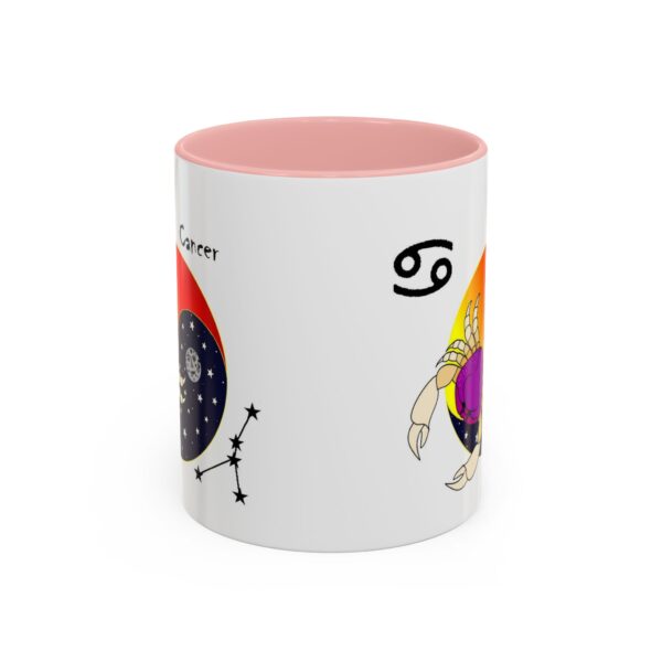 A pink and white mug with an image of the zodiac sign.