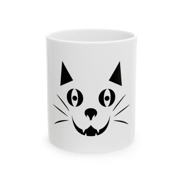 A white coffee mug with an image of a cat 's face.