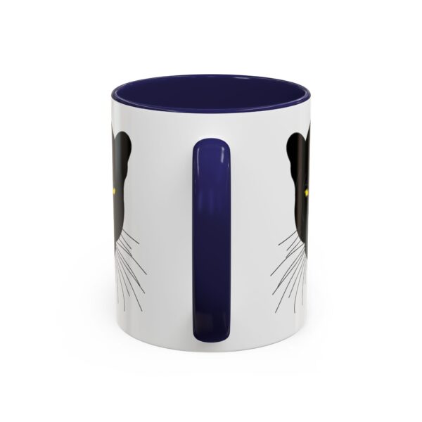 A white and blue mug with a cat design on it.