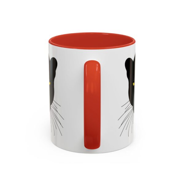 A red and white mug with a picture of a cat.