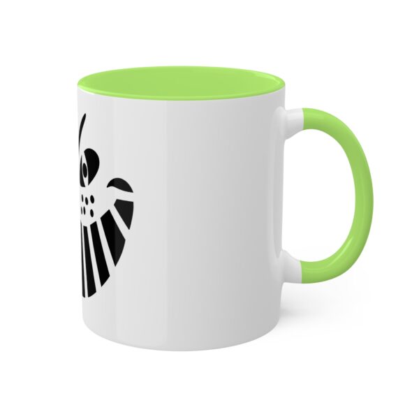 A green and white coffee mug with the shield of loki on it.