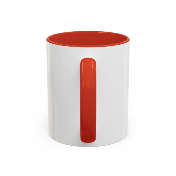 A white and red coffee mug with the handle up.