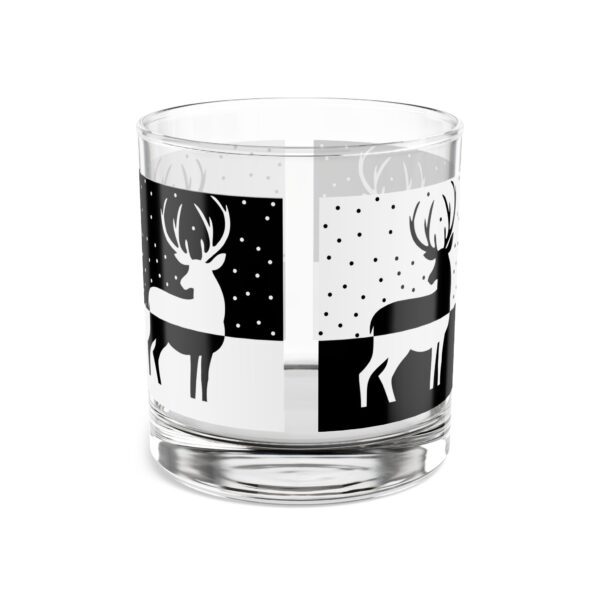 A glass with deer on it and black and white design.