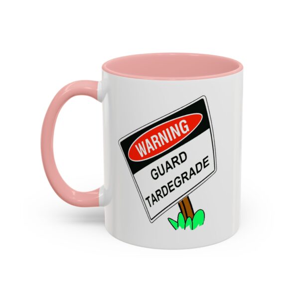 A pink and white mug with a warning sign on it