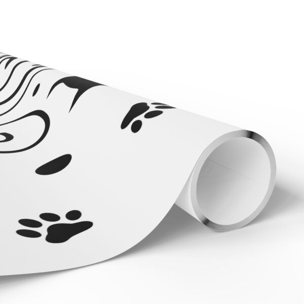 A roll of wrapping paper with a woman 's face and paw prints.