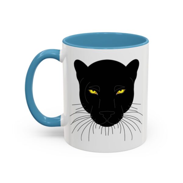 A mug with a black cat face on it