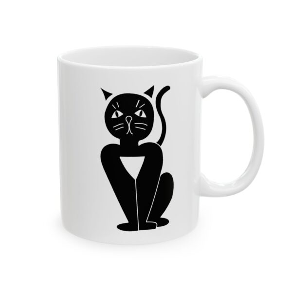 A white mug with a black cat sitting on it's side.