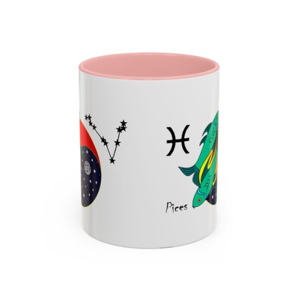 A pink and white mug with the pisces zodiac sign on it.