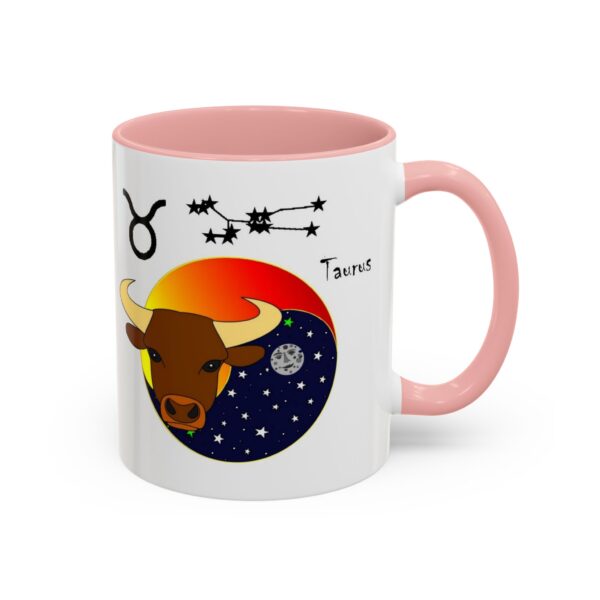 A pink and white mug with the zodiac taurus on it.