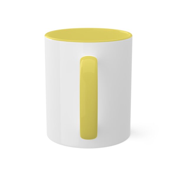 A white mug with yellow on the side.