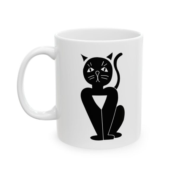 A white mug with a black cat sitting on it's side.