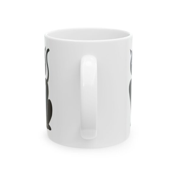 A white coffee mug with a black and white design.