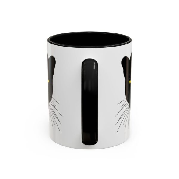 A black and white coffee mug with a cat design.