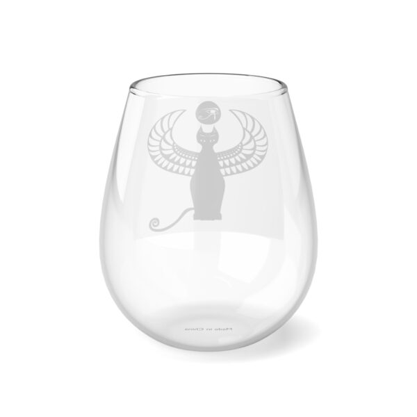 A glass with a cat and a ball inside of it