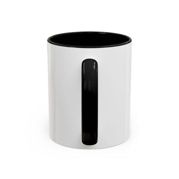 A white and black mug with the handle up.