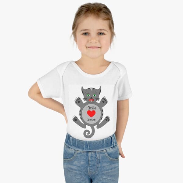 A girl wearing jeans and a t-shirt with an image of a cat.