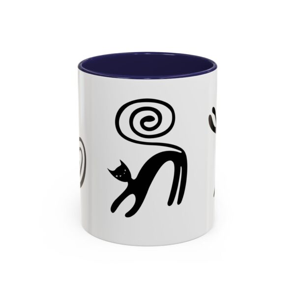 A white mug with black cats on it.