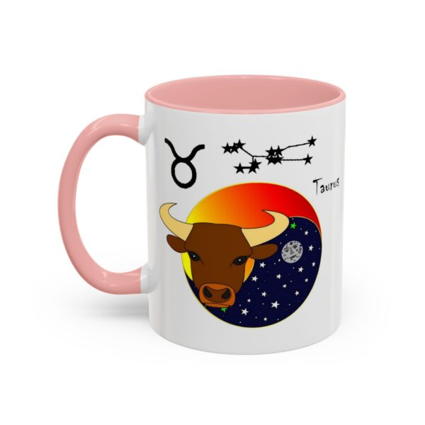 A pink and white mug with the zodiac sign taurus on it.