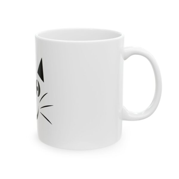 A white coffee mug with a cat on it.