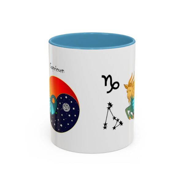 A blue and white mug with some zodiac symbols on it