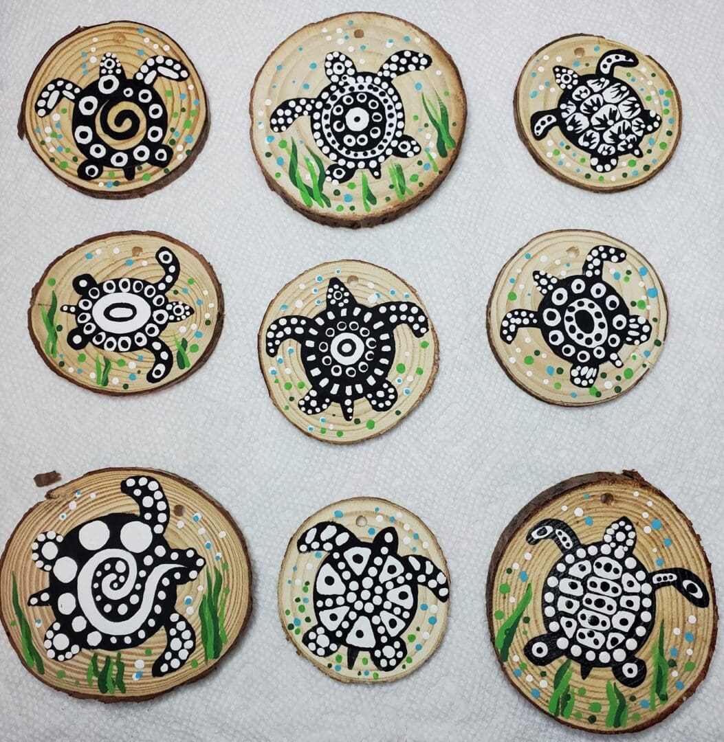 A group of wood slices with black and white designs on them.