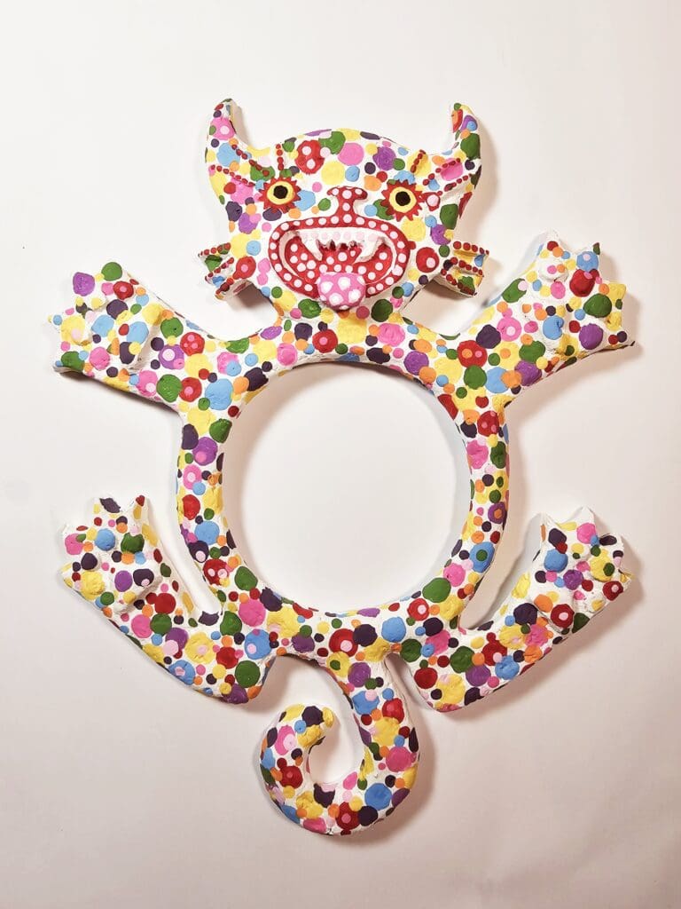 A colorful animal shaped picture frame with flowers.