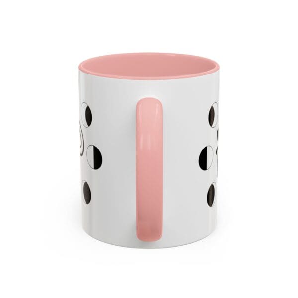 White mug with pink handle and dots.