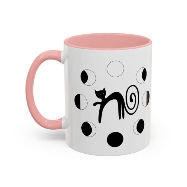 Cat-patterned mug with pink handle.