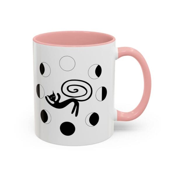 Black cat design on a pink-handled mug.