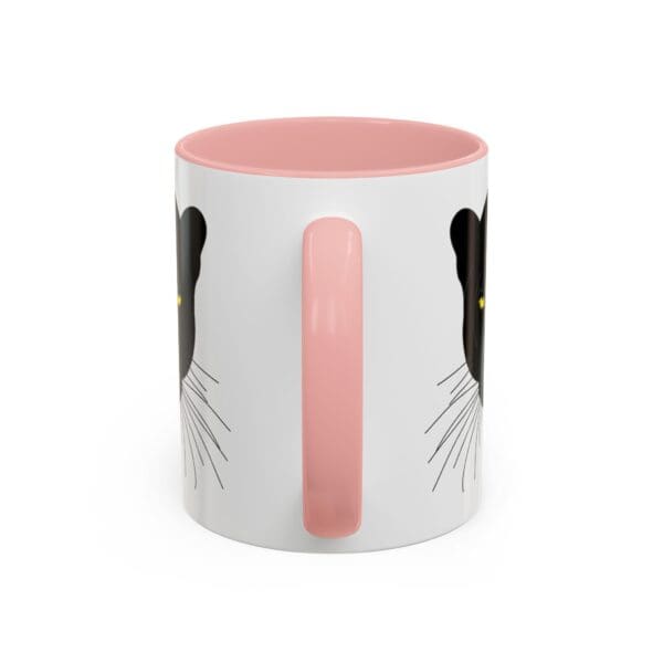 Cat-themed mug with pink handle.