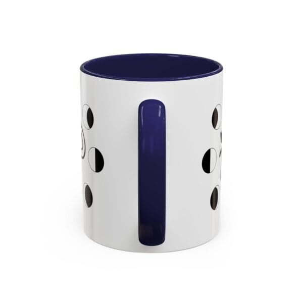 White mug with navy blue handle and holes.