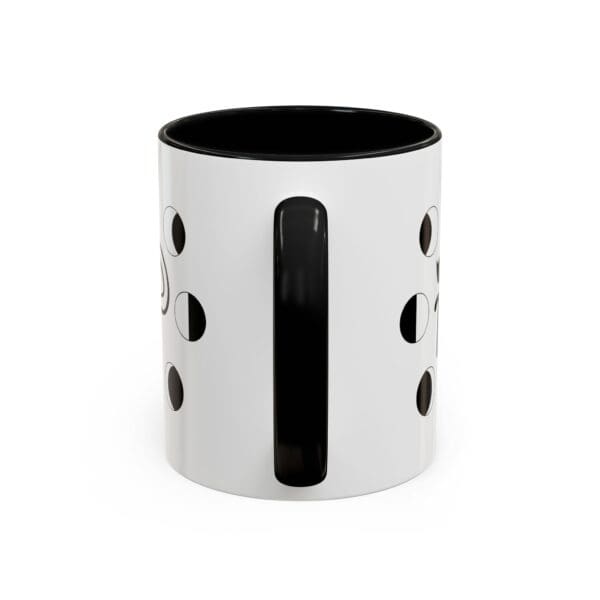 White mug with black handle and design.