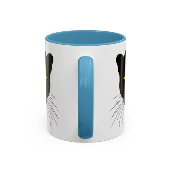 Cat-themed mug with blue handle.