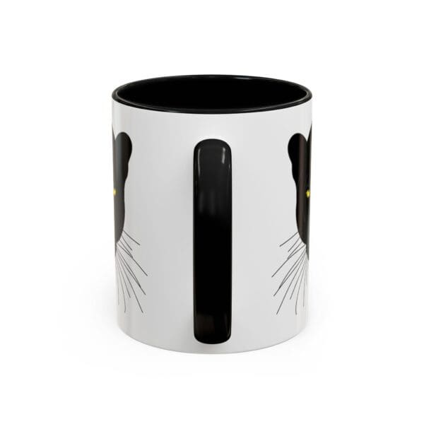 Cat-themed mug with black and white design.