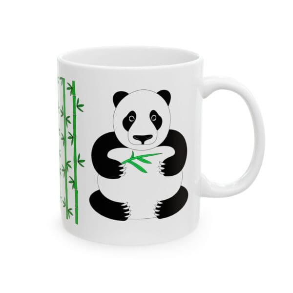 Panda holding bamboo on a coffee mug.